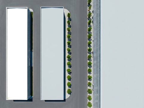 Top down aerial view of parallel industrial buildings and trees