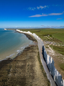 aerial view, blue sky, british tourism, chalk cliffs, clear sky, cliff face, coastal cliffs, coastal erosion, coastline, daytime, destination, drone photo, east sussex, eastbourne, england, english ch