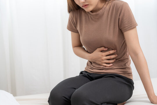 stomach ache. Asian women have abdominal pain, indigestion, gastritis, menstrual cramps, flatulence, diarrhea, distention, colon cancer, belly inflammation problem, suffer food poisoning, abdomen