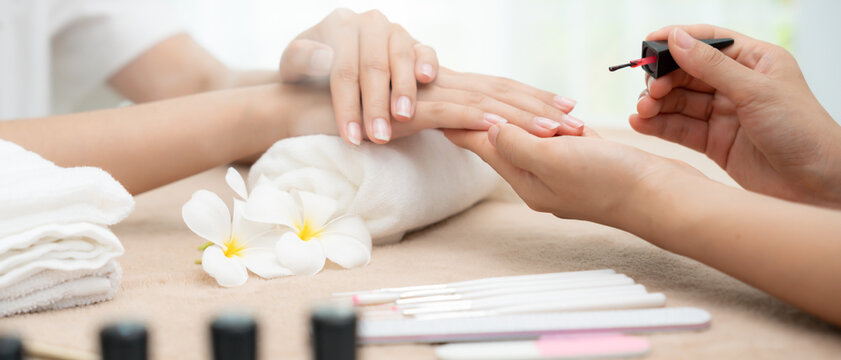 Woman receive care service by professional Beautician Manicure at spa centre. Nail beauty salon use nail file for Glazing treatment. manicurist make nail customer to beautiful. body care spa treatment