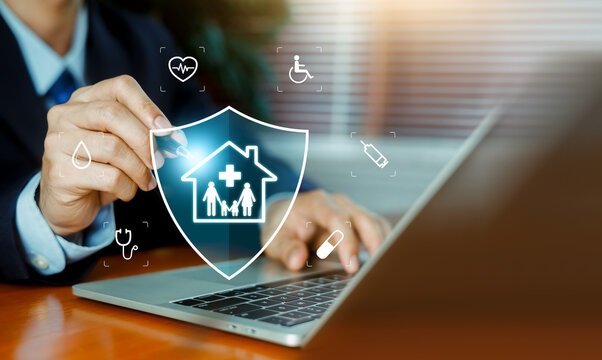 Professional working on laptop with virtual health insurance shield and medical icons. Concept of family health care protection, medical insurance policy, and wellness security system.