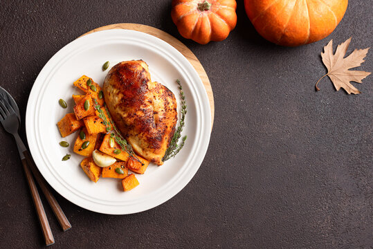 Autumn meal: roasted chicken breast and pumpkin with herbs