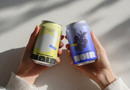 Hands Holding Two Colorful Soda Cans Mockup PSD In Natural Light
