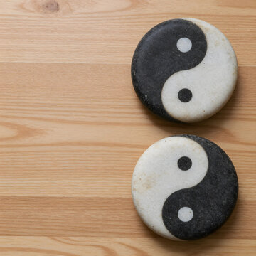 Balance and harmony concept yin yang stone symbols on wooden background for mindfulness meditation wellness and spiritual health and inner peace