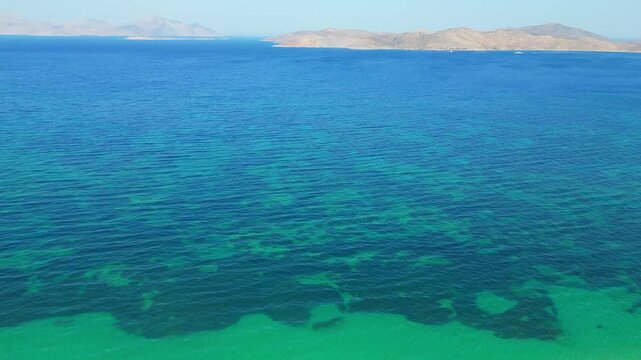 Drone footage capturing the wild and scenic sandy coastline of Flamingo beach with turquoise sea water near Tigkaki village on Kos island, Greece.