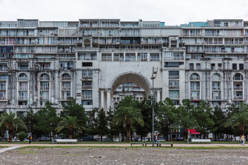 Fototapeta premium Residential complex architecture with weathered facade, concrete balconies and deterioration represents maintenance issues, aging housing, dense urban development and property rehabilitation.