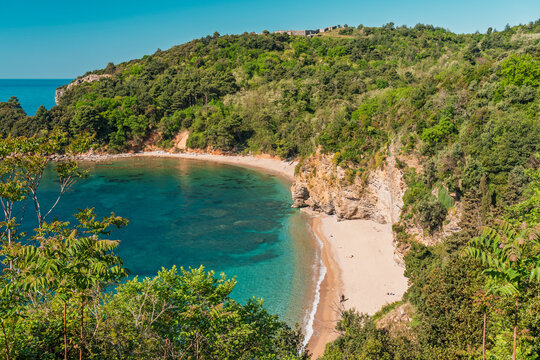 A scenic view of a hidden Mogren beach cove in summer, Montenegro