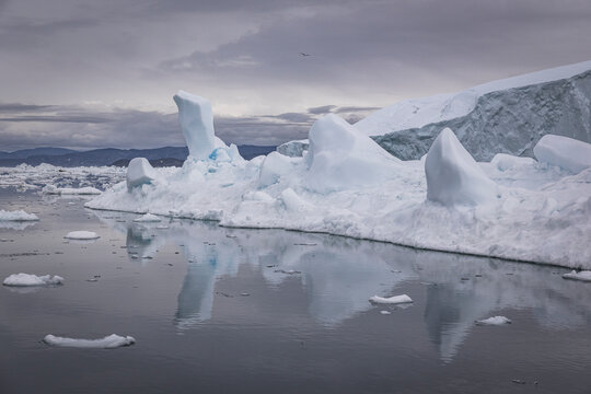Icebergs and glaciers reflected in calm arctic waters