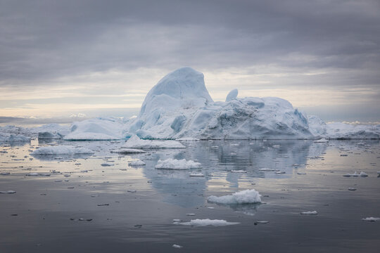 Massive icebergs floating in the calm arctic ocean