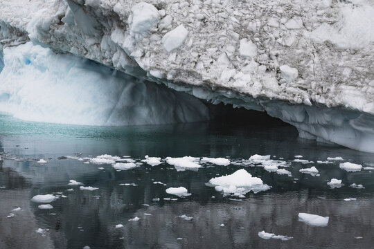 A close up of a melting dirty glacier face