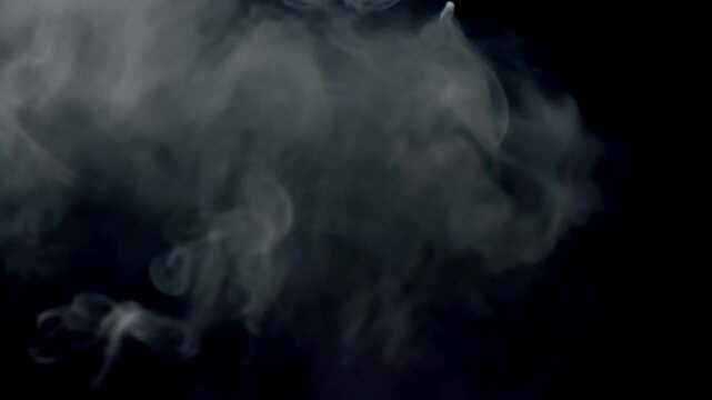 White smoke curls and billows through dark space, forming shifting translucent plumes and soft abstract shapes in atmospheric slow motion footage