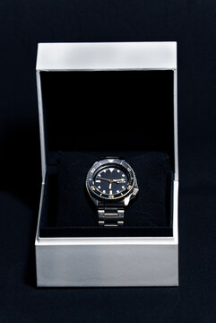 Luxury Men Diver Wristwatch in Open White Gift Box on Dark Background