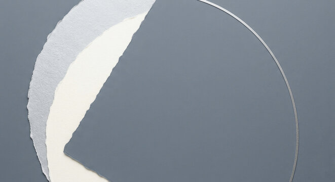 Abstract composition of layered torn paper sheets in shades of grey and white for new year design