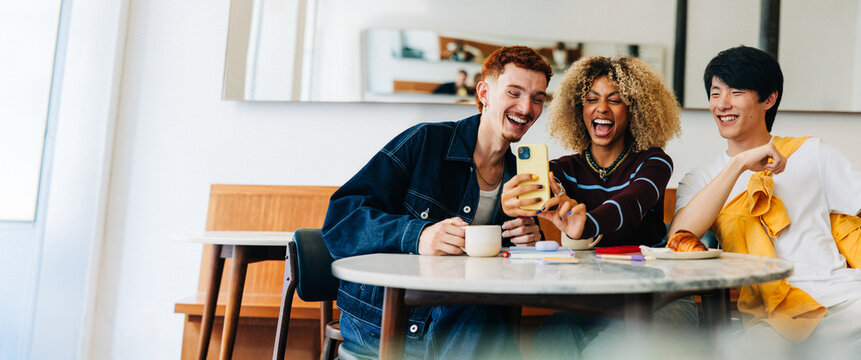 Friends laughing together while taking a selfie