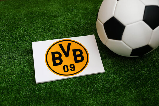 A football on the grass and the Borussia Dortmund Football Club logo. September 30, 2026.