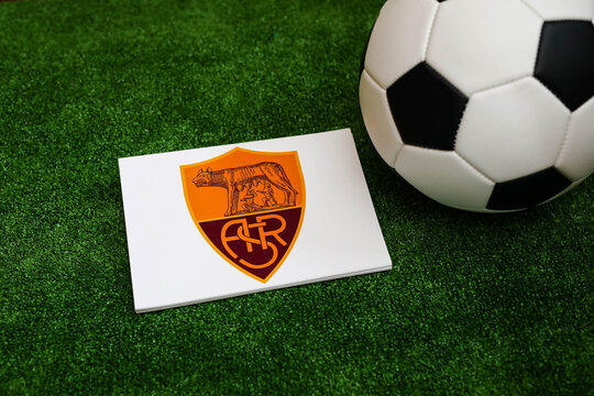 A football on the grass and the AS Roma Football Club logo. September 30, 2026.