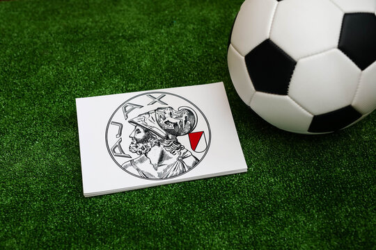 A football on the grass and the Ajax Football Club logo. September 30, 2026.