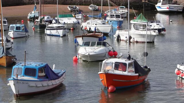 Small colourful boats in Paignton Harbour as tide is rising. Devon. Autumn. 2026