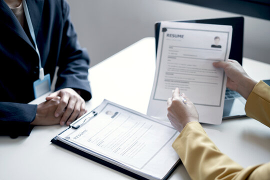 Business people hold a resume and talk to job applicants for job interviews about careers and Their personal history in the company. Recruitment concepts