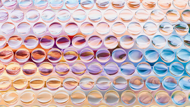 Close-up of water droplets reflecting vibrant color gradient
