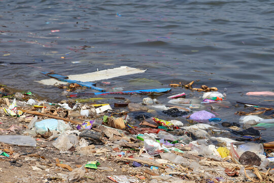 Plastic waste and marine debris polluting a coastal beach in Jepara, Indonesia, highlighting environmental damage, ocean contamination, ecological crisis, and threat to marine life sustainability.