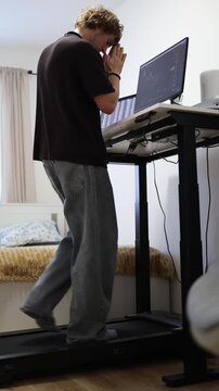 Vertical screen trader prays in front of market charts hoping stock prices will rise while anxiously watching the screen and waiting for a profitable change in the market