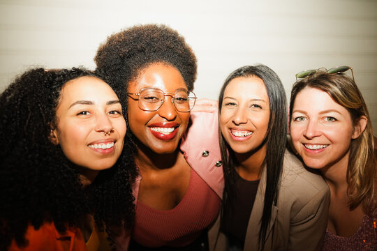 Multiracial girls having fun in the streets after party concert - People lifestyle and nightlife concept - Main focus on center right woman face - UGC flash content