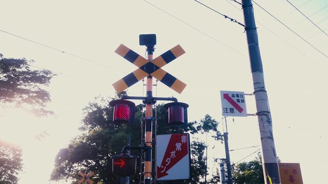 Railroad crossing signal standing along empty railway track in countryside of Hokkaido, Japan. Infrastructure, fixed 4K video.