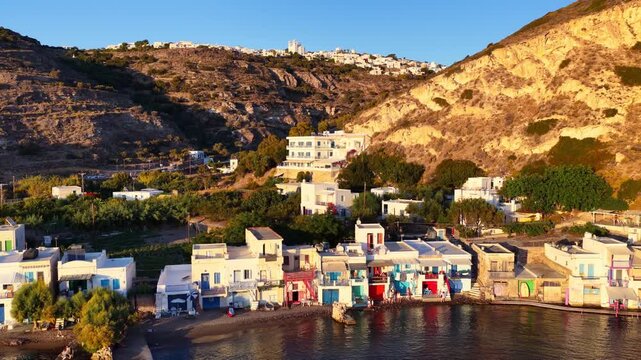 drone shot of sunset on the coast of Milos, Klima village on Milos island in the Cyclades, Greece, vacation and tourism in Greece