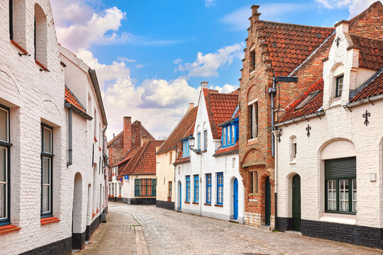Vintage street in Bruges Belgium with blue sky and white cloud. Europe landscape panorama old town.