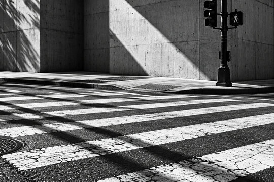 Monochrome Urban Crosswalk and Concrete Wall with Dramatic Shadows