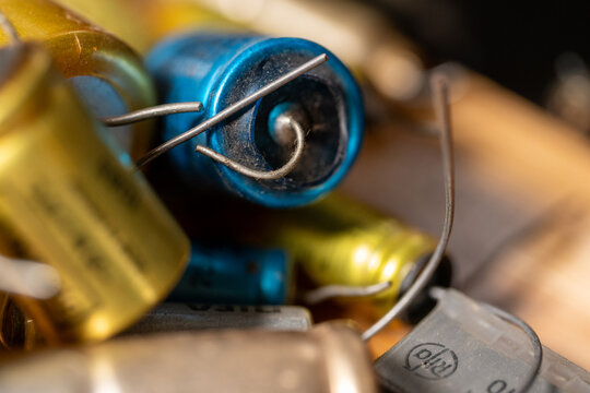 Electrolytic capacitors. close up of capacitors in different sizes and colors.