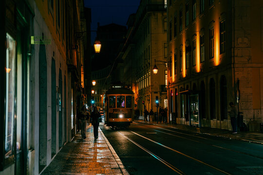 A yellow Lisbon tram 28 (number 582, destination M. Moniz) with a.