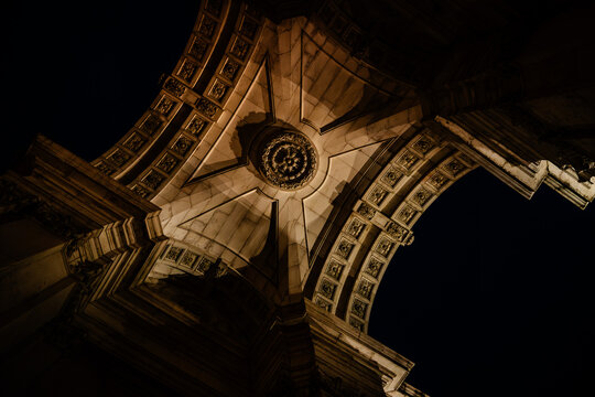A dramatic low-angle upward view of the underside of the Rua Augusta.