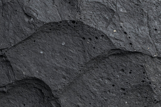 Vesicular basalt rock surface with gas pores macro