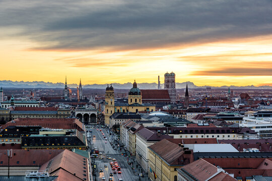 The sun sets over the city skyline of Munich in Germany