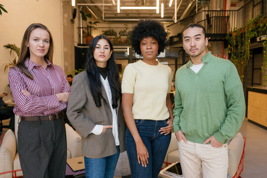 Confident business team standing together in a modern office