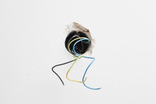 Germany, Cologne, Hole for socket with wires, close up
