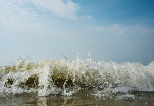Waves breaking in the surf at North Sea coast in the Netherlands