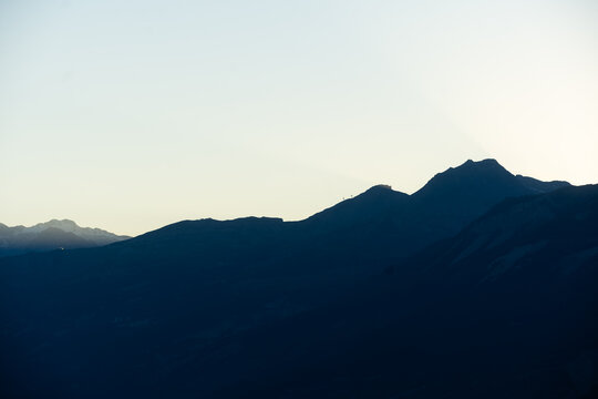 Majestic scenery of rough mountain ridge near grassy hills 