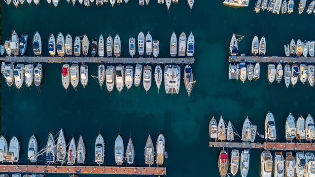 An aerial view shows moored yachts in a blue marina
