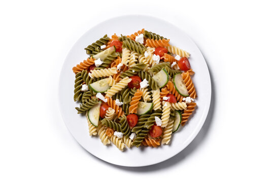Colorful tricolor pasta salad isolated on white background