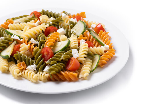 Colorful tricolor pasta salad isolated on white background