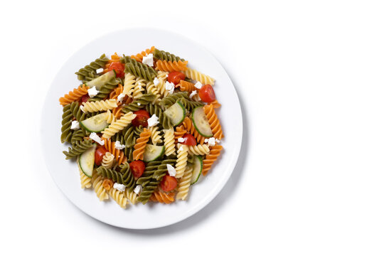 Colorful tricolor pasta salad isolated on white background. Top view. Copy space