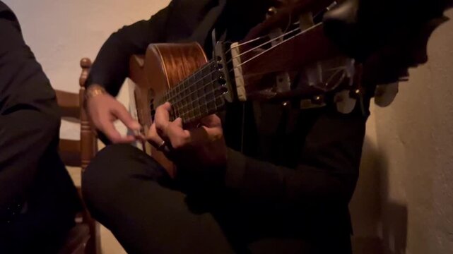 Virtuoso flamenco guitar playing by a male musician, showcasing Spain's rich musical customs and intense expression. Travel and culture blogs