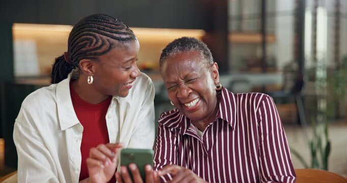 Phone, laugh and senior mother with adult daughter, funny social media post or discussion on weekend. Happy, elderly mom and black woman in home with tech, online comedy video or humor for connection