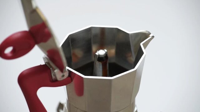 coffee maker, Moka pot brewing coffee, high-angle three-quarter view