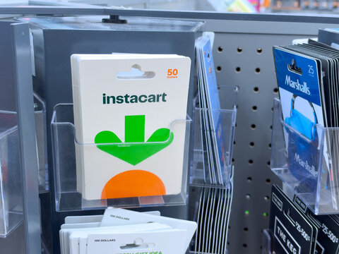 Calgary, AB, Canada. Oct 1, 2026. Instacart gift cards displayed in a rack at a retail store shelf with other brand cards visible.