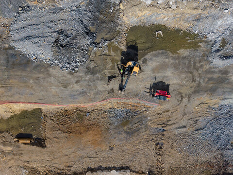 Aerial view of an active construction site featuring heavy excavators and earthmoving equipment working on a large plot of land in Istanbul, Istanbul, Turkiye.