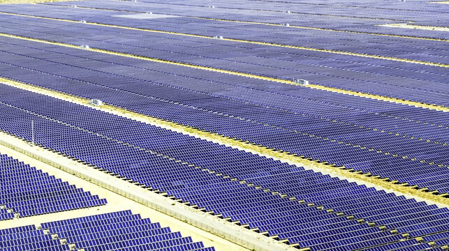Aerial view of massive rows of solar panels stretching across the desert landscape in Los Angeles, California, United States.